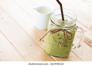 Iced Matcha Latte On Wood Background