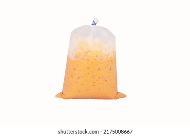 Iced milk tea color orange with crushed ice in a plastic bag . Refreshing drink is popular in tropical countries. Isolated on white background. - Shutterstock ID 2175008667