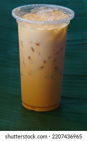 
Iced Milk Tea On A Green Background Is Obtained From Banana Leaves And Can Be Studied.