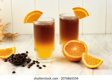 Iced Orange Espresso Coffee Mocktail Cold Brew Tonic Spritz on White Background, Concept Menu for Coffee Shop