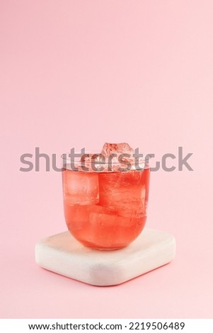 Iced pink chamomile omija drink. Refreshing camellia ice tea. Vertical orientation, copy space.