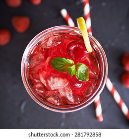 iced raspberry cocktail with lemon and mint shot top down