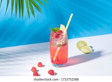 iced red raspberry punch cocktail with lime in glass on color background. summer drink. - Powered by Shutterstock