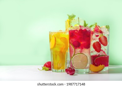 Iced Refreshing Drink. Bar And Cafe Beverage Menu Background. Set Of Various Cold Summer Cocktails  - Peach Tea, Lemonade, Mojito, Cherry Mocktail, With Fruits On Colorful Bright Green Background 