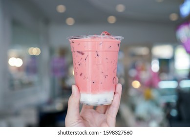 Iced Rose Tea With Bubble\boba. Hand Holding A Plastic Cup Of Rose Milk Tea With Pink Color, Topped With Bubble\boba Jelly Pearls.