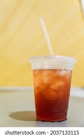 Iced Tea In Clear Plastic Drink Cup With Clear Straw