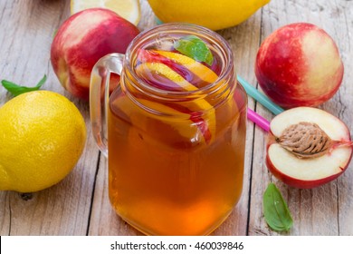 Iced tea with lemon and peach in a Mason jar. Selective focus