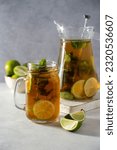 Iced tea with lime and ice in mason jar. Summer refreshing drink.