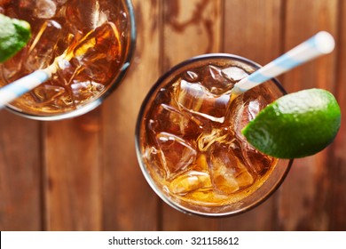 iced tea with lime wedge with retro paper straw shot top down