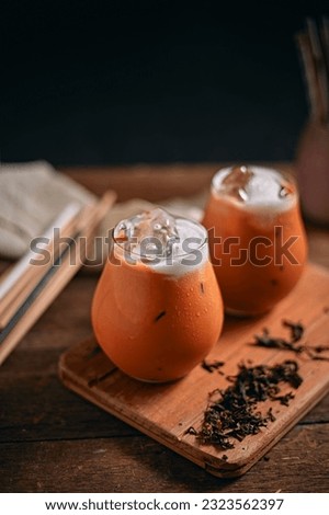 Iced thai milk tea in glass, selective focus