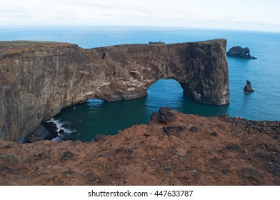 Iceland, 09/18/2012: aerial view of the gigantic black arch of lava standing in the sea on the promontory of Dyrholaey overlooking the bay of Vik i Myrdal, the southernmost village of the island - Shutterstock ID 447633787