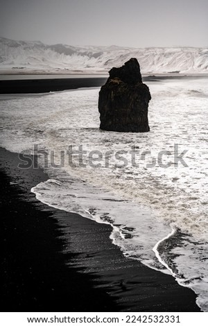 Iceland black beach Reynisfjara in Vik from Dyrholaey (Dyrhólaey) viewpoint. Coastline of black sand beach in Iceland. Arnardrangur. Black sand beach