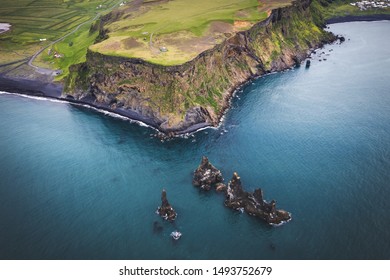 Iceland, Dyrholaey cape. Aerial landscape photo by drone. Amazing volcanic terrain of Iceland from above. Dyrholaey is spot of Golden Circle touristic path in Iceland. Black sand beach nearby Vik.