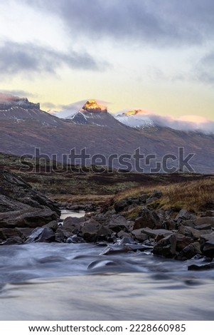 Iceland Fjord sunset glowing white mountain peaks moving river