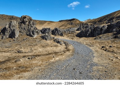 Iceland hiking trail walking path between cliffs on a rugged barren landscape