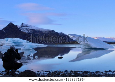 Iceland - November 2 2018: Man taking a picture of Jokulsarlon Lake in Iceland