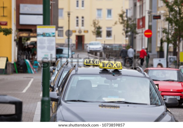 ICELAND, REYKJAVIK - AUGUST 20, 2012: Cars\
traffic on Reykjavik street with vacant\
taxi
