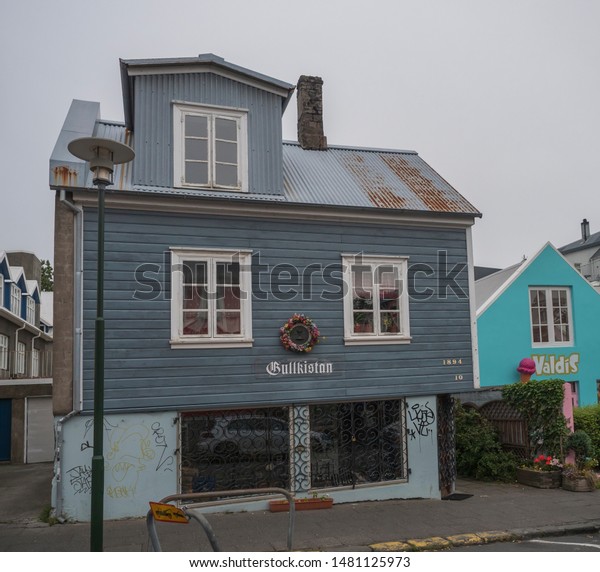 Iceland, Reykjavik, July\
30, 2019: street in Reykjavik center with old historic blue sheet\
metal house