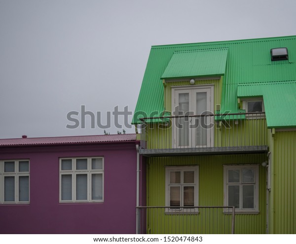 Iceland,\
Reykjavik, July 30, 2019: street in Reykjavik center with old\
historic pink and green sheet metal\
houses.