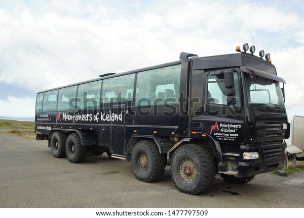 ICELAND,\
REYKJAVIK - JUNE 16, 2019: Summer day in the south of Iceland and a\
tourist bus all-terrain vehicle on a car\
site