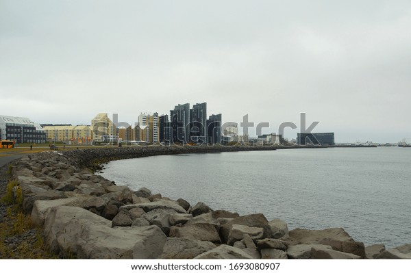 ICELAND, REYKJAVIK - JUNE 26,\
2019: Gloomy summer day and a walk along the picturesque city\
promenade