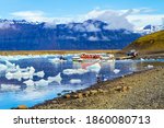 ICELAND, SCAFTAFETL PARK, ICE LAGOON JOKULSAURLOUN - July 10, 2014: The icebergs and ice floes. Picturesque yellow boat for a sightseeing tour. The concept of northern and photo tourism