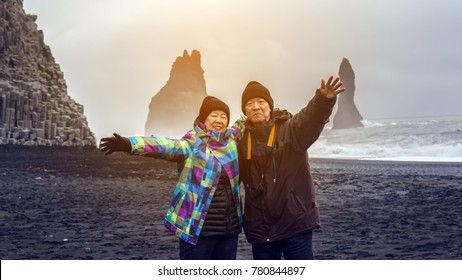 Iceland senior couple tourist at black beach
