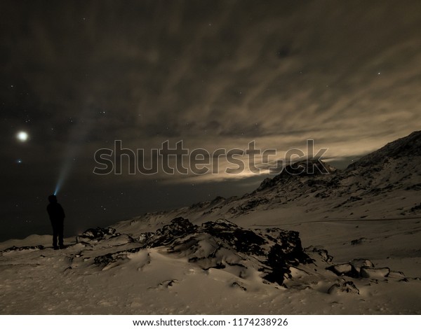 Iceland stargazing\
with headlamp during\
night