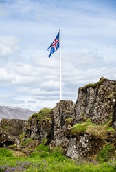 Icelandic Flag Flowing In The Air With Green Grass Around It