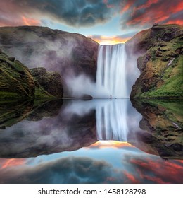 Icelandic Landscape. Classic long exposure view of famous Skogafoss waterfall with reflections. Dramatic Scenery of Iceland during sunset. majestic Skogafoss Waterfall in countryside with colorful sky - Powered by Shutterstock