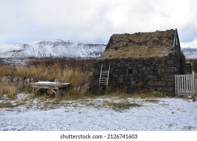 Icelandic turf house in snowy landscape. made of stone, wood, birch and turf. magical tiny home with with small ladder in wilderness - Powered by Shutterstock