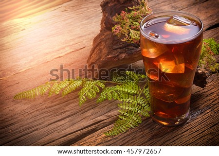 icetea and green leaf on rustic wooden table