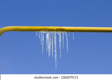 Icicle On The Yellow Gas Tube. Prevent And Thaw Frozen Pipes  Concept