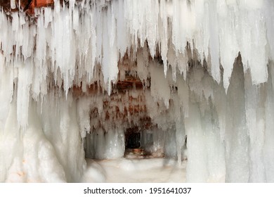 Icicles Framing Ice Cave With Red Stone On Apostle Islands, Wisconsin 