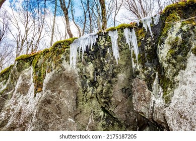 Icicles On Mossy Rock Face Cliff, Appalachian Forest In Winter, Blue Sky And Clouds, Blue Ridge Mountains