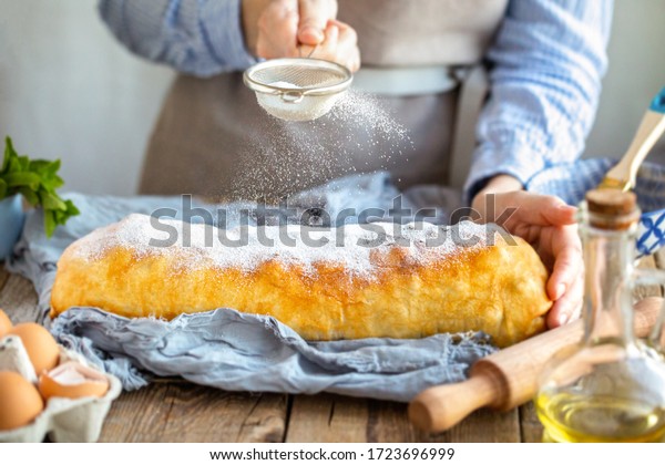 Icing sugar powder. Sprinkle icing sugar\
cake. The cook sprinkles powdered apple strudel. Icing sugar\
powder. Powdered sugar flies for\
dessert\
