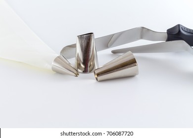 Icing Tips With Cream Bag And Cake Scraper For Decorating Cakes And Cookies With Frosting Isolated On White Background