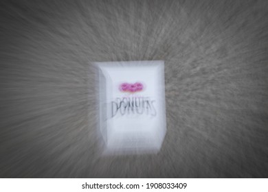 ICM Photography Of An Empty Donut Box Laying On The Ground