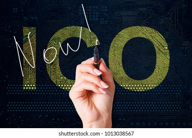 ICO Procedure Initial Coin Offering Poster. The Female Hand Is Writing The Word Now On The PC Circuit Board.