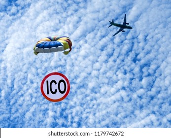 ICO Sign Is Flying On A Parachute From An Airplane. Airdrop Token. Giveaway.