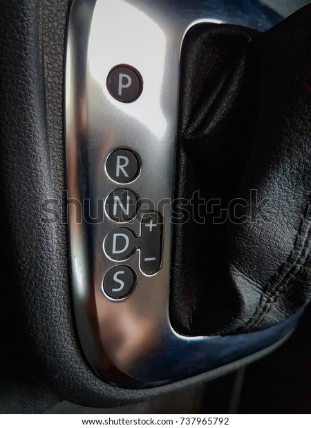 Icon near a floor selection\
lever of car with automatic transmission gear shift. Car\
interior