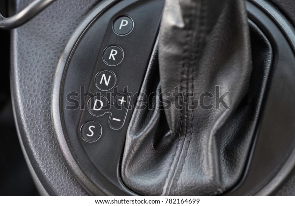 Icon near a floor selection\
lever of car with automatic transmission gear shift. Car\
interior