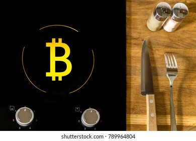 A Icon Of Virtual Electronic Gold Money Bitcoin On The Electric Plate Hob. The Concept Of Finance And Food. The Concept Of High Quality Food In A Elite Restaurant. Business Lunch Concept