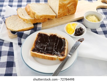 The Iconic Australian Spread Vegemite On To A Slice Of Fresh Bread.