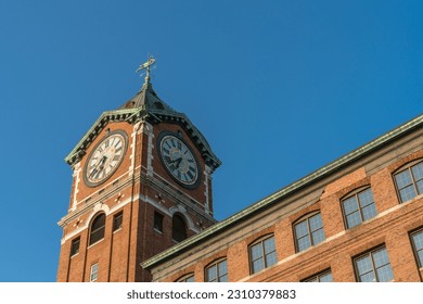 Iconic Ayer Mill clock tower and nineteenth century brick mill building in the historic immigrant city of Lawrence Massachusetts.
