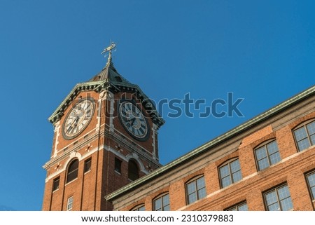 Iconic Ayer Mill clock tower and nineteenth century brick mill building in the historic immigrant city of Lawrence Massachusetts.
