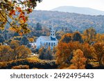 Iconic church in Stowe Vermont with colorful fall foliage.