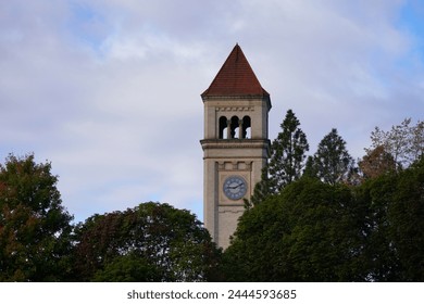 Iconic Clock Tower With Four Clocks Standing Tall Above a City Tree Scape