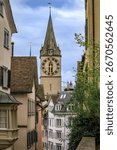 The iconic clock tower of St. Peter s Church framed by surrounding historic buildings in the Old Town or Altstadt of Zurich, Switzerland