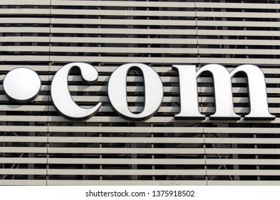 The iconic dot com Internet domain placed on a large retail store facade